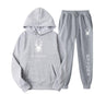 .A casual sports outfit consisting of a long-sleeved hooded t-shirt and elastic-waist pants.